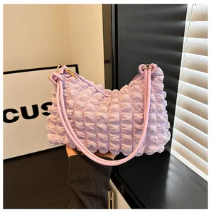 Macro detail of lavender pleated bubble fabric texture and golden zipper on shoulder bag