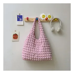 Detailed macro view of pink bubble pleated texture on stylish tote bag fabric
