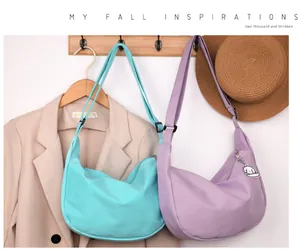 Detail view of waffle texture crossbody bags in mint green and lilac with dog charm