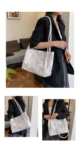 Close-up of white tote bag with green butterfly prints and woven rope handle details