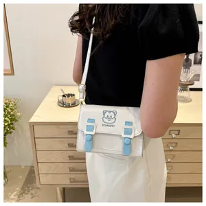 Close-up of cute cartoon cat embroidery on white PU leather crossbody bag