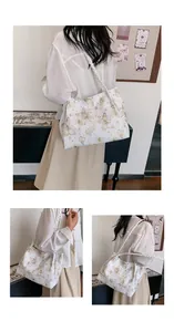 Detail view of a white tote bag with gold butterfly prints and woven rope handles