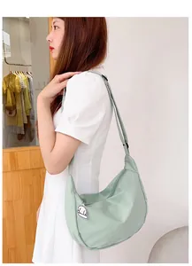 Detail of mint green waffle corduroy hobo bag with a cute dog pendant accessory