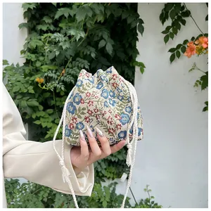 Detailed view of vintage floral jacquard canvas bucket bag with cotton drawstring closure