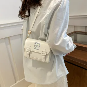 White PU leather crossbody bag with blue cartoon cat embroidery and gold hardware