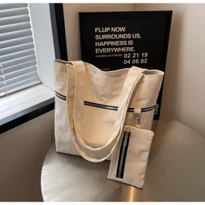 Off-white tote bag set with wide shoulder strap and matching small zipper pouch