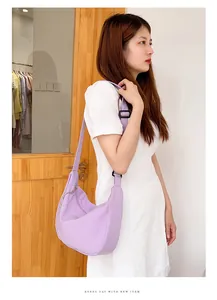 Detailed side view of lavender waffle texture crescent bag with adjustable strap