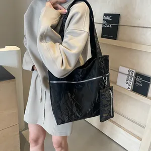 Chic black crinkled patent leather tote bag with silver zipper and mini coin purse charm