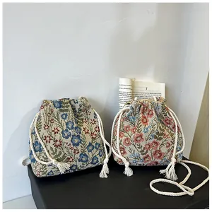 Macro detail of drawstring canvas bucket bag featuring floral jacquard weaving and cotton rope