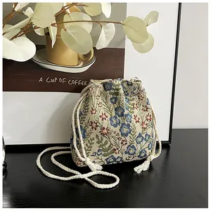 Detail of floral jacquard bucket bag with cotton drawstring and tassel ornaments