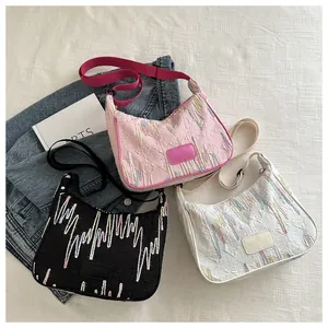 Detail view of stylish nylon bags featuring embossed patterns and branded labels on texture