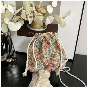 Detail of floral jacquard bucket bag with drawstring closure and soft cotton rope strap