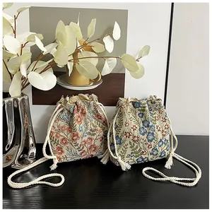 Detailed view of floral jacquard drawstring bucket bags with elegant white cotton ropes