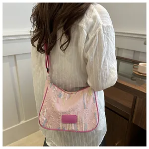 Detail of pink nylon shoulder bag with FF embossed pattern and colorful embroidery