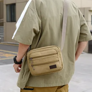 Men's khaki canvas crossbody bag with multiple zipper compartments for casual outdoor wear