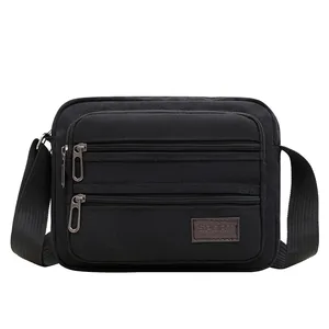Men's durable black canvas crossbody shoulder bag with multiple zippered compartments