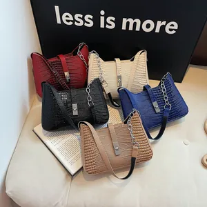 Detailed view of crocodile pattern shoulder bags in five colors with metal chain straps