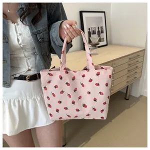Detailed texture of pink corduroy tote bag with cute strawberry pattern and soft handles