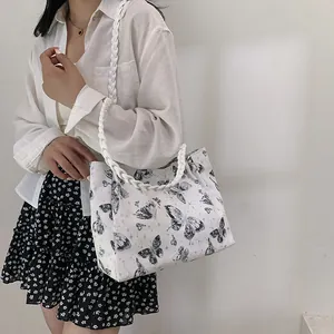 Large cream tote bag with black butterfly prints and thick woven rope shoulder straps