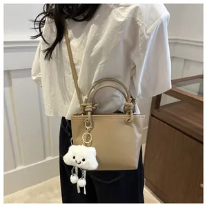 Detail of khaki bucket bag with lychee grain leather and fluffy cloud charm