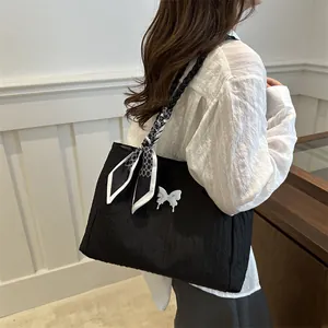French style black tote bag with white butterfly and geometric scarf on model