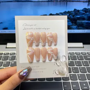 Detail of nude press-on nails with 3D crystal rhinestones and pearl accents