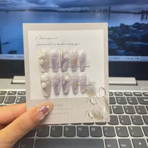 Macro detail of long ballerina nails with 3D white roses and purple gradient glitter