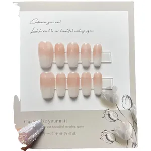 French gradient press-on nails set with pearl accents and milky white fade design