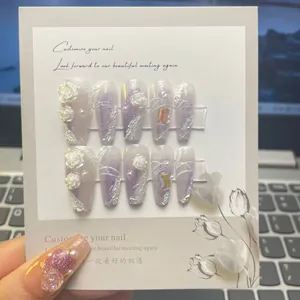 Detail of handmade lilac gradient press-on nails with 3D roses, pearls and crystals