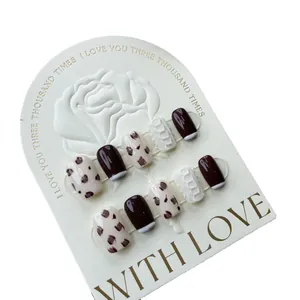 Short square cow print press-on nails with chocolate brown and textured sweater design