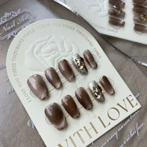 Deep brown cat-eye press-on nails with silver glitter and geometric rhinestones