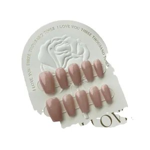 Glossy pink coffin press-on nails set of 10 pieces on elegant rose embossed card