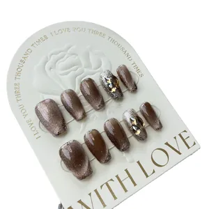 Handmade brown cat eye press-on nails with silver glitter and champagne rhinestones