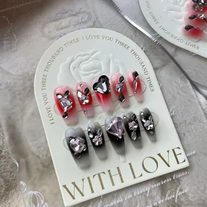 Handmade gradient press-on nails with black hearts and 3D floral gemstone decorations