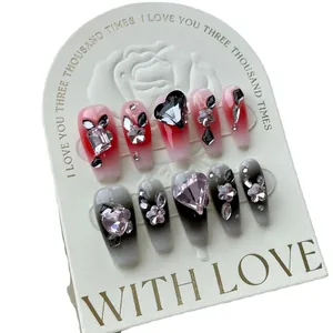 Handmade coffin false nails set featuring red and black gradient with heart rhinestones