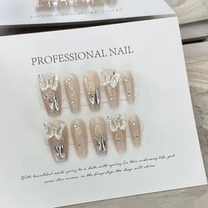 Handmade press-on nails in nude pink with silver butterfly and glitter gradient