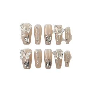 Handmade gradient nude press-on nails with 3D butterfly charms and silver glitter accents