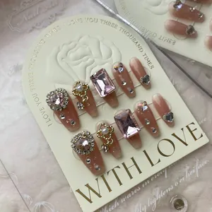 Handmade nude pink gradient press-on nails with luxury rhinestones and crystal charms