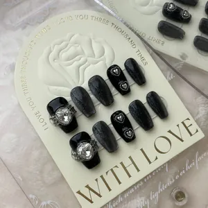 Handmade dark black cat-eye press-on nails set with large heart rhinestones and silver studs