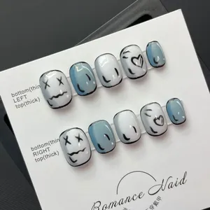 Handmade blue and white press-on nails with cartoon graffiti and heart patterns