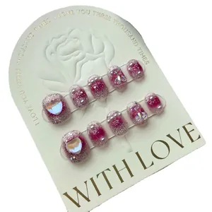 Handmade press-on nails with pink glitter, pearl accents and 3D gummy bear charms
