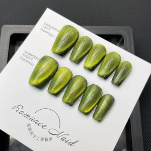 Handmade emerald green cat-eye press-on nails in long coffin shape with glitter finish