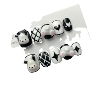 Handmade press-on nails featuring cute 3D cartoon panda and dog designs in black and white