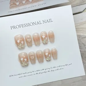 Handmade almond press-on nails with apricot gradient and hand-painted white tulips