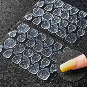 Detailed view of double-sided transparent jelly glue tabs for press-on nail application