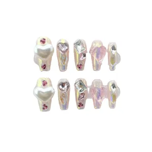 Pink aurora press-on nails with 3D heart charms, pearls and crystals in long coffin shape