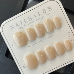 Handmade glossy nude press-on nails set displayed on professional sizing card