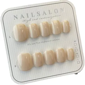Handmade glossy nude beige press-on nails in short square round shape on display card