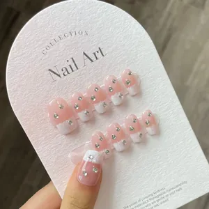 Pink gradient French press-on nails with silver rhinestones and gothic cross accents