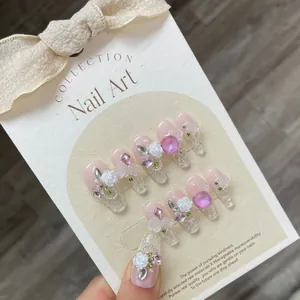 Handmade press-on nails with 3D white camellia floral relief and purple rhinestones